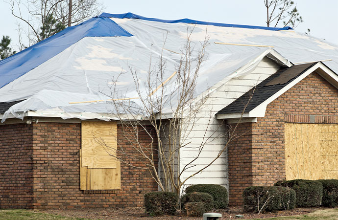 Placing A Tarp Over Fire Damaged Areas