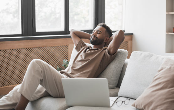 man relaxing on sofa at home in good indoor air quality