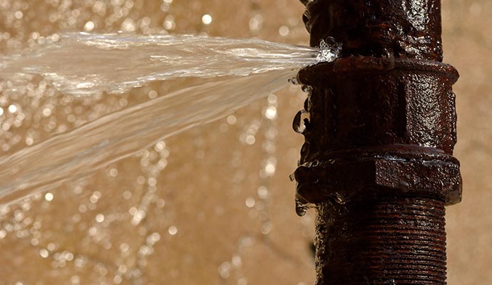 Water leaking from a rusty pipe
