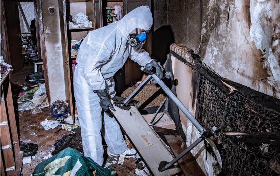 a perosn restoring an area damaged by fire