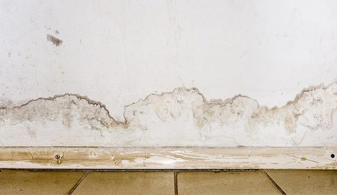 white wall with brownish stains due to water damage